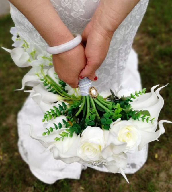 A hand holding a flower