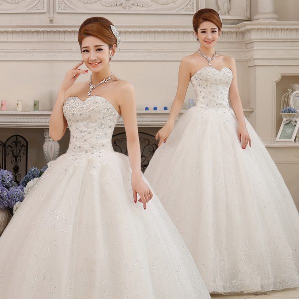 A couple of people that are standing in a wedding dress
